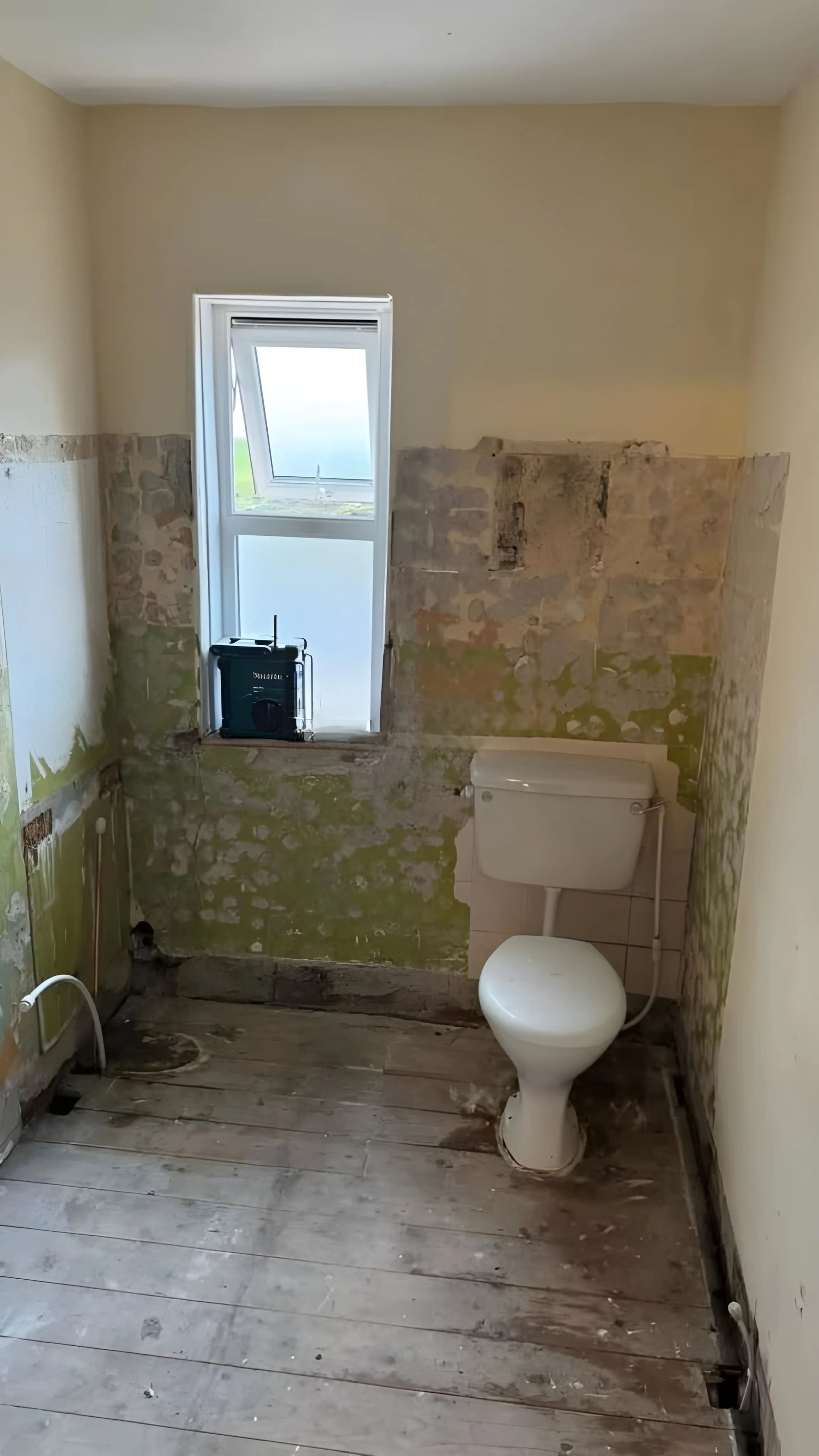 Old bathroom with worn-out tiles before renovation
